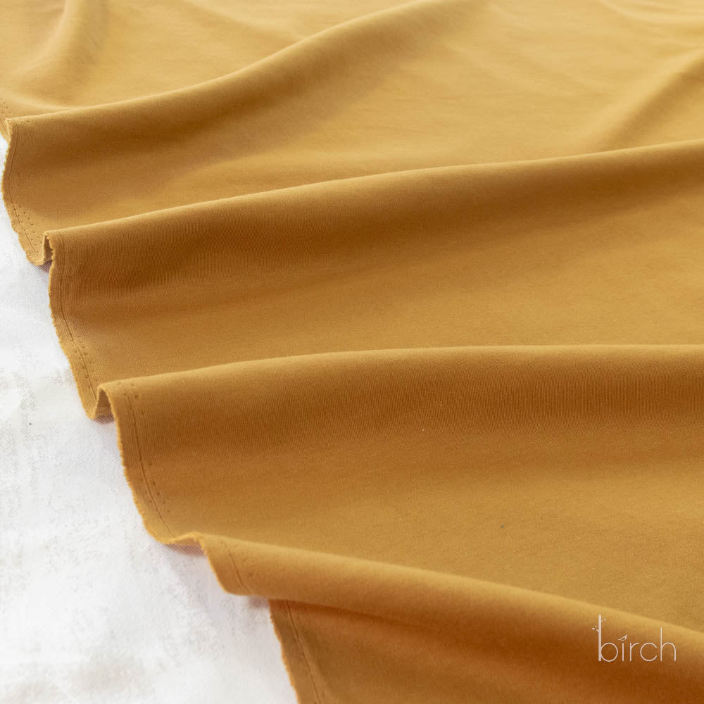 Ochre Solid Interlock Knit by Birch Organic