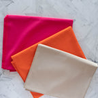 Flamingo Tangerine Nest Solid Poplin by Birch Fabrics