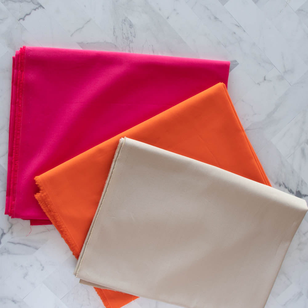 Flamingo Tangerine Nest Solid Poplin by Birch Fabrics