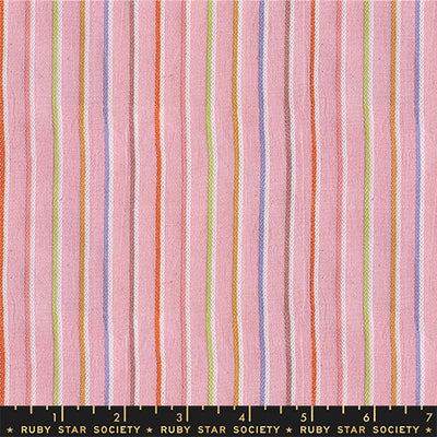 Fabric with multicolored vertical stripes on a pink background, featuring the Ruby Star Society label. Collection of colorful fabric swatches with various patterns on a white background Warp & Weft Mystic Fable Yarn Dyed Woven Fabrics by Alexia Marcelle Abegg for Ruby Star Society for Moda Fabrics