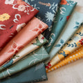 Collection of colorful fabric swatches with various patterns on a neutral background
