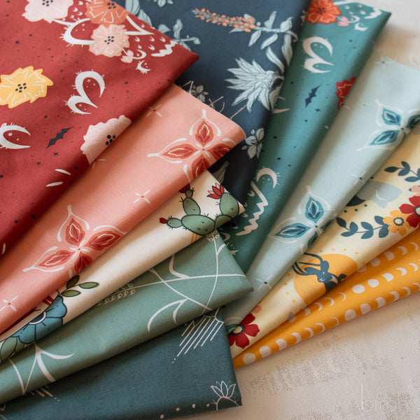Collection of colorful fabric swatches with various patterns on a neutral background