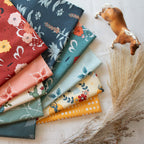 Collection of colorful fabric swatches with floral patterns on a light surface.